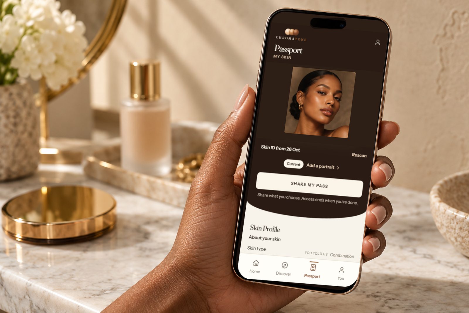 A hand holding a phone showing her Chromatone Beauty Passport.